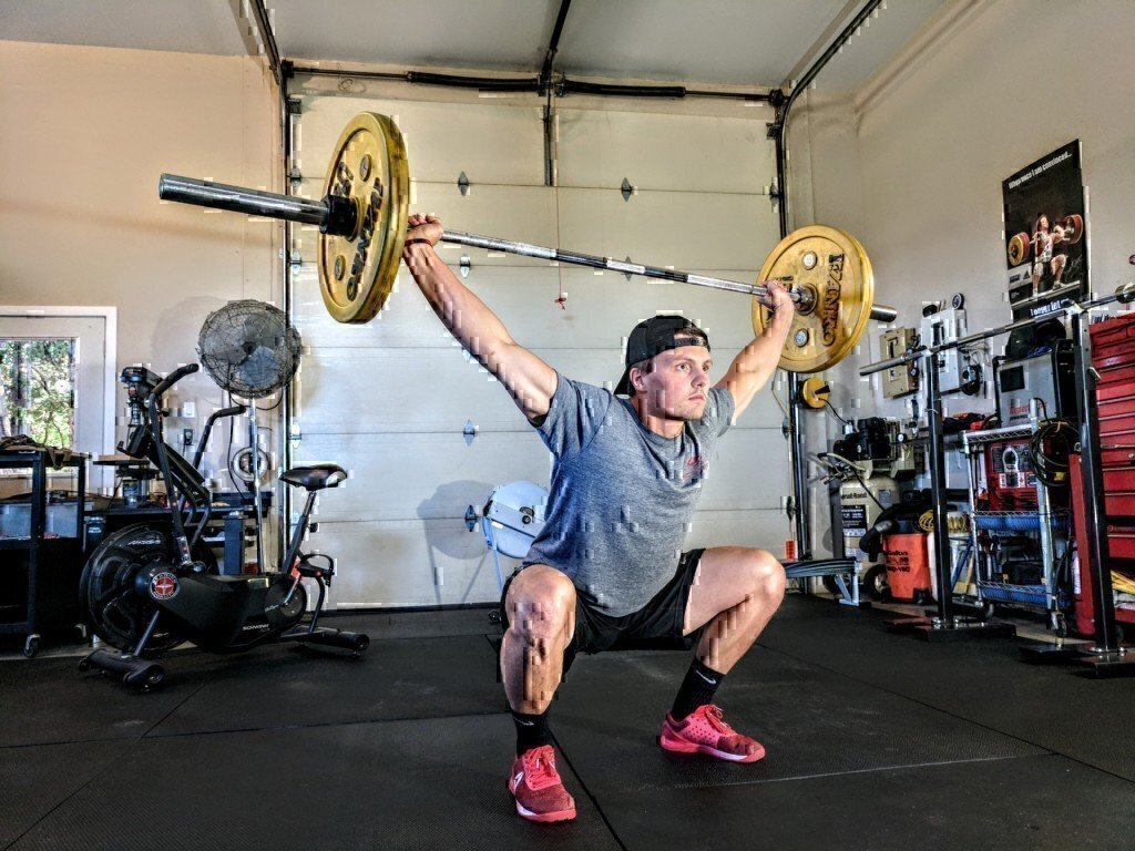 a man doing barbell exercises