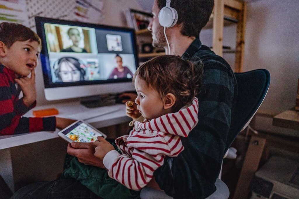 This veteran chose to work from home so he could spend more time with his family. Now he sits on a virtual call while he watches his kids.