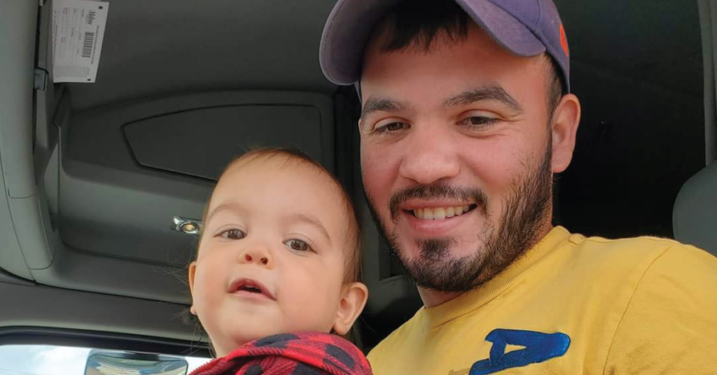 Sam Rojas, Navy Veteran, proudly showing His son his job as a truck driver