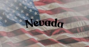 Waving United States flag with the word 'Nevada' centered across the stripes in black text,