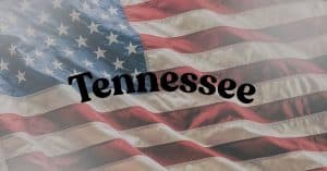 Waving American flag with the word Tennessee across the center in bold black letters