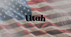 Utah written in bold black letters over a waving American flag background.