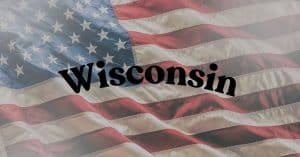 American flag as a backdrop with the word Wisconsin in bold black letters across the stripes, conveying a Wisconsin-themed banner.