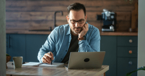 Working adult studying an online degree program on a laptop at home.